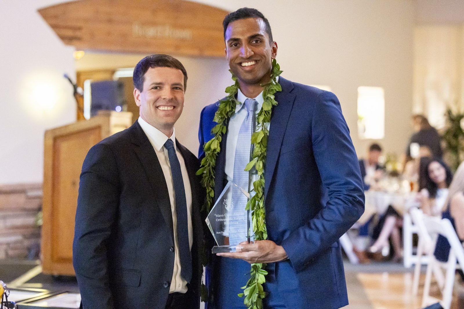 Dr. Tummala holding an award from the Mayo Clinic Arizona orthopaedic surgery residency