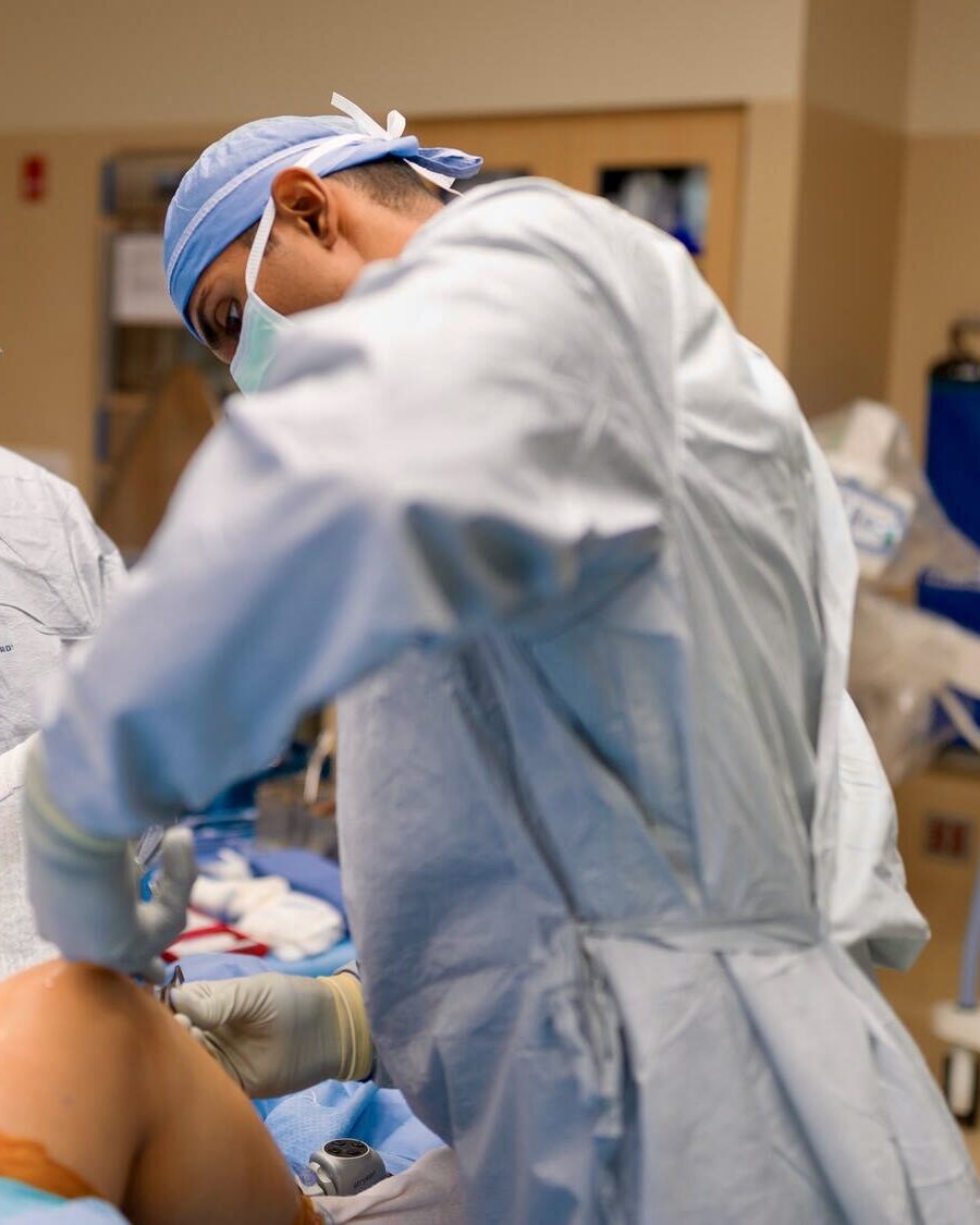 Dr. Tummala operating with the surgical team